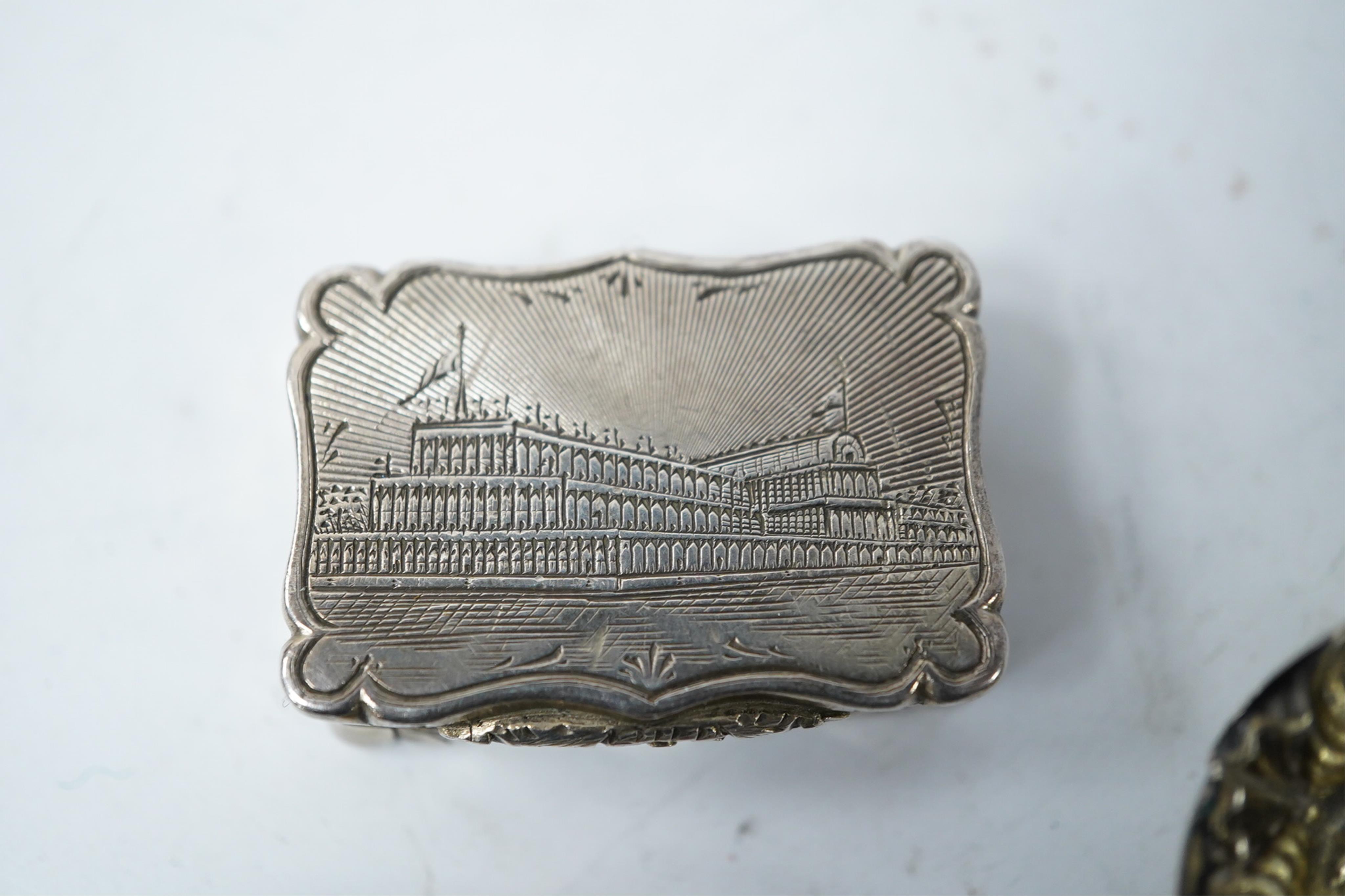 A Victorian silver shaped rectangular vinaigrette, engraved with a scene to commemorate The Great Exhibition at the Crystal Palace in Hyde Park, London, by William Dudley, Birmingham, 1850, 33mm, together with three smal